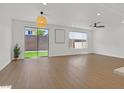 Bright living space with wood-look floors and backyard views through sliding glass doors at 8043 Texas Hills St, Las Vegas, NV 89113