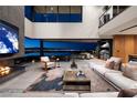 Elegant living room with fireplace, open floor plan, city views, and seamless access to outdoor patio at 811 Magnum Cliff Ct, Henderson, NV 89012