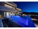 Luxurious home featuring an infinity pool with views, modern design, and seamless indoor-outdoor living at 811 Magnum Cliff Ct, Henderson, NV 89012