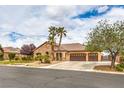 Attractive single-story home with a three-car garage, desert landscaping, and a neutral stucco exterior at 8216 Tursi Lodge Ct, Las Vegas, NV 89131