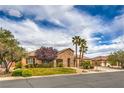 Charming single-story home with desert landscaping and a stone facade, featuring an attached three-car garage at 8216 Tursi Lodge Ct, Las Vegas, NV 89131