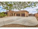 Single-story home showing a spacious driveway leading to an attached three-car garage at 8216 Tursi Lodge Ct, Las Vegas, NV 89131