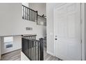 Bright entryway featuring soaring ceilings, open staircase with wooden railings, and new flooring at 9526 Summer Furnace St, Las Vegas, NV 89178