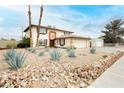 Spacious two-story home with desert landscaping and rock accents in the front yard at 408 N Torrey Pines Dr, Las Vegas, NV 89107