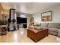 Cozy living room with wood laminate flooring, a sectional sofa, and ample natural light at 408 N Torrey Pines Dr, Las Vegas, NV 89107