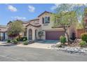 Charming two-story home featuring a two-car garage and landscaped front yard at 10135 Haymarket Peak Ave, Las Vegas, NV 89166