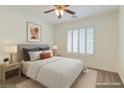 Bright bedroom with a neutral palette, a ceiling fan, and plantation shutters for privacy at 10241 Headrick Dr, Las Vegas, NV 89166