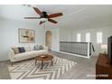 Upstairs bonus room with ceiling fan, art and a stairway, ideal for lounging or entertaining at 10241 Headrick Dr, Las Vegas, NV 89166