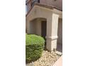 Beige two-story home featuring a covered entrance and desert landscaping at 10282 Keystone Pastures St, Las Vegas, NV 89183