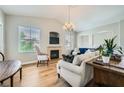 A bright living room with ample seating, a fireplace, wood floors and backyard views at 10550 W Alexander Rd # 2179, Las Vegas, NV 89129