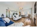 Bright and spacious living room featuring hardwood floors, a vaulted ceiling, and stylish furniture at 10550 W Alexander Rd # 2179, Las Vegas, NV 89129