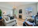 Open living area with a fireplace, hardwood floors, a chandelier, and comfortable seating at 10550 W Alexander Rd # 2179, Las Vegas, NV 89129
