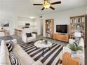 Bright open-concept living room featuring modern furnishings and seamless flow to the kitchen area at 1405 S Nellis Blvd # 2087, Las Vegas, NV 89104