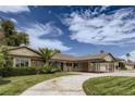 Charming single-story home featuring a covered carport, mature landscaping, and a circular driveway at 1712 Chapman Dr, Las Vegas, NV 89104