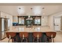 Spacious eat-in kitchen featuring an oversized marble island, stainless steel appliances, and tile backsplash at 1712 Chapman Dr, Las Vegas, NV 89104