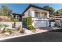 Inviting two-story home with a tile roof, balcony, well-maintained landscaping, and an attached garage at 2017 Plaza De Cielo, Las Vegas, NV 89102