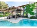 Backyard with a covered patio, outdoor seating, and a private pool for relaxation and entertainment at 2017 Plaza De Cielo, Las Vegas, NV 89102