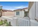 Inviting side patio area with a gated entrance, perfect for outdoor relaxation and entertaining at 2525 Willow Wren Dr, North Las Vegas, NV 89084