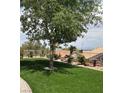 Lush backyard featuring well-manicured artificial lawn and manicured landscaping around the perimeter at 2708 Hope Forest Dr, Las Vegas, NV 89134
