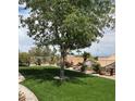 Lush backyard featuring well-manicured artificial lawn and manicured landscaping around the perimeter at 2708 Hope Forest Dr, Las Vegas, NV 89134