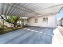Covered parking area next to the house with mature landscaping and a concrete driveway at 2732 Johannson Ln, Las Vegas, NV 89115