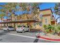 Exterior view showing covered parking and lush landscaping of these well maintained residential buildings at 2801 N Rainbow Blvd # 102, Las Vegas, NV 89108