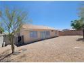 View of the property's rear exterior and backyard, showcasing desert landscaping at 3012 Silver Canyon Ln, North Las Vegas, NV 89031