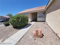 A charming home entrance with desert landscaping and a stone feature at 3012 Silver Canyon Ln, North Las Vegas, NV 89031