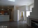 Open-concept living area with tile flooring and a fireplace at 3401 Conan St # 103, Las Vegas, NV 89129