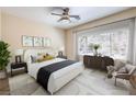 Cozy bedroom features a large window, ceiling fan, and neutral decor at 35 Glade Water Dr, Henderson, NV 89052