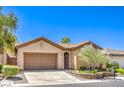 Tan single-story home featuring a well-maintained front yard, greenery, and brown garage door at 35 Glade Water Dr, Henderson, NV 89052