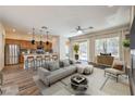 Open-concept living room boasts an eat-in kitchen, modern decor, and natural light at 35 Glade Water Dr, Henderson, NV 89052