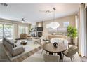 Bright living room features modern furniture, fireplace, and natural light from large windows at 35 Glade Water Dr, Henderson, NV 89052