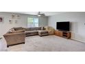 Cozy living room featuring a large sectional sofa, a comfy beanbag, and a modern entertainment center at 351 Nativo Ave, North Las Vegas, NV 89031