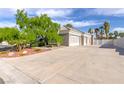 Long driveway leading to a large garage in this single story home, surrounded by mature landscaping at 3684 Mooncrest Cir, Las Vegas, NV 89129