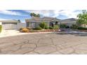 Charming single-story home featuring a detached garage and a well-manicured front yard with mature landscaping at 3684 Mooncrest Cir, Las Vegas, NV 89129