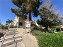 Well-maintained condo building with a sign for Building 1, surrounded by mature trees and landscaping at 3740 Desert Marina Dr # 12, Laughlin, NV 89029