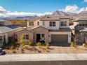Charming two-story home with a well-manicured front yard, attached garage, and mountain views at 421 Malpaso St, Las Vegas, NV 89138