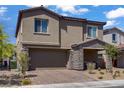 Charming two-story home with a stone-accented front porch and well-maintained landscaping at 4436 Mural Glen Ct, North Las Vegas, NV 89084