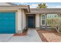 Close-up of the front entrance, showcasing the decorative front door and well-kept landscaping at 4813 Canadian Dr, Las Vegas, NV 89130