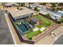 Private backyard oasis featuring a pool, spa, putting green, and ample patio space at 5120 Lone View Pl, Las Vegas, NV 89149