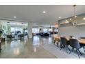 Open-concept living space featuring a dining area with modern lighting and stylish decor at 5120 Lone View Pl, Las Vegas, NV 89149