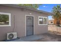 Side of the house with white trim and a chain link fence at 5867 Bunch St, Las Vegas, NV 89122