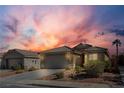 Exterior view of home with tile roof, desert landscaping, and beautiful sunset at 5965 Sierra Medina Ave, Las Vegas, NV 89139