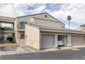 Condominium featuring stucco walls, tile roofing, attached garage, with a vehicle parked inside at 6250 W Flamingo Rd # 51, Las Vegas, NV 89103