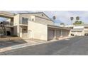 Condominium featuring stucco walls, tile roofing, attached garage, and a second-floor entrance with stairs at 6250 W Flamingo Rd # 51, Las Vegas, NV 89103