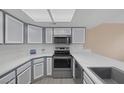 Bright kitchen features stainless steel appliances, gray cabinets and new countertops at 6250 W Flamingo Rd # 51, Las Vegas, NV 89103