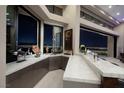 Stylish bar area with marble countertops, offering stunning city views through large windows at 661 Dragon Peak Dr, Henderson, NV 89012