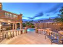 Spacious backyard featuring a built-in pool, lounge chairs and covered patio perfect for relaxation at 8204 Antler Pines Ct, Las Vegas, NV 89149