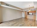Spacious living area with wood-style floors, neutral paint, and view into kitchen at 8255 S Las Vegas Blvd # 1404, Las Vegas, NV 89123